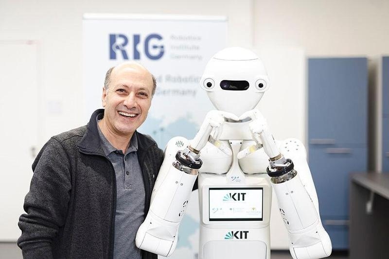 Prof. Tamim Asfour together with the ARMAR-7 humanoid robot.